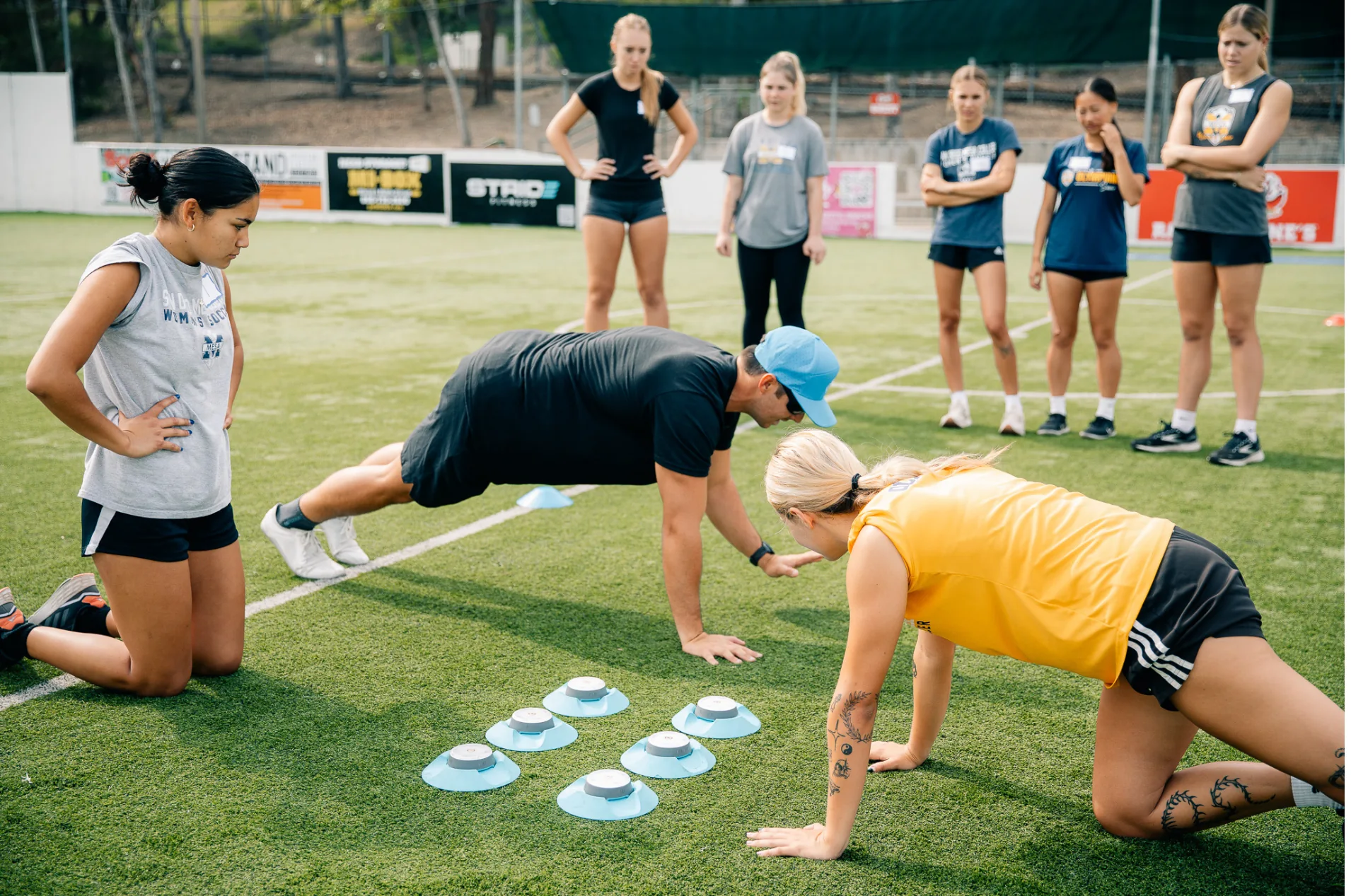 Athletes performing a guided movement screen on the field